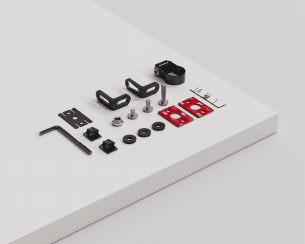 Alt text: An assortment of neatly arranged camera mounting hardware including screws, brackets, spacers, and a hex key on a white surface against a white background.